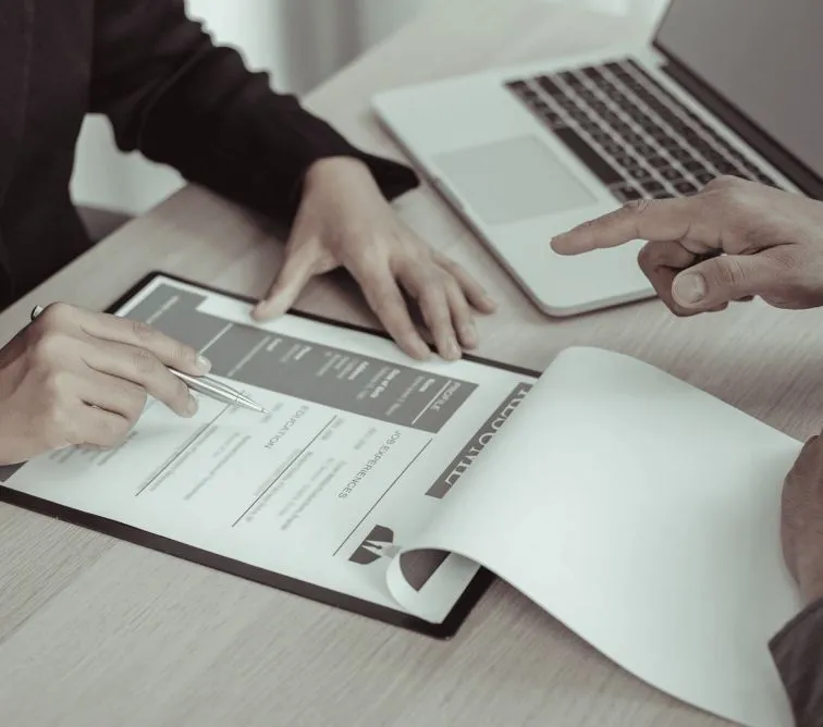 Two people reviewing a document on a tablet