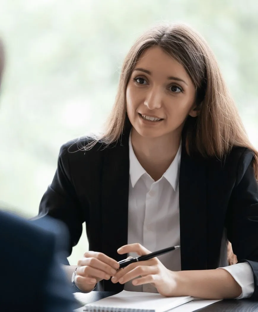 A candidate in an interview, taking notes